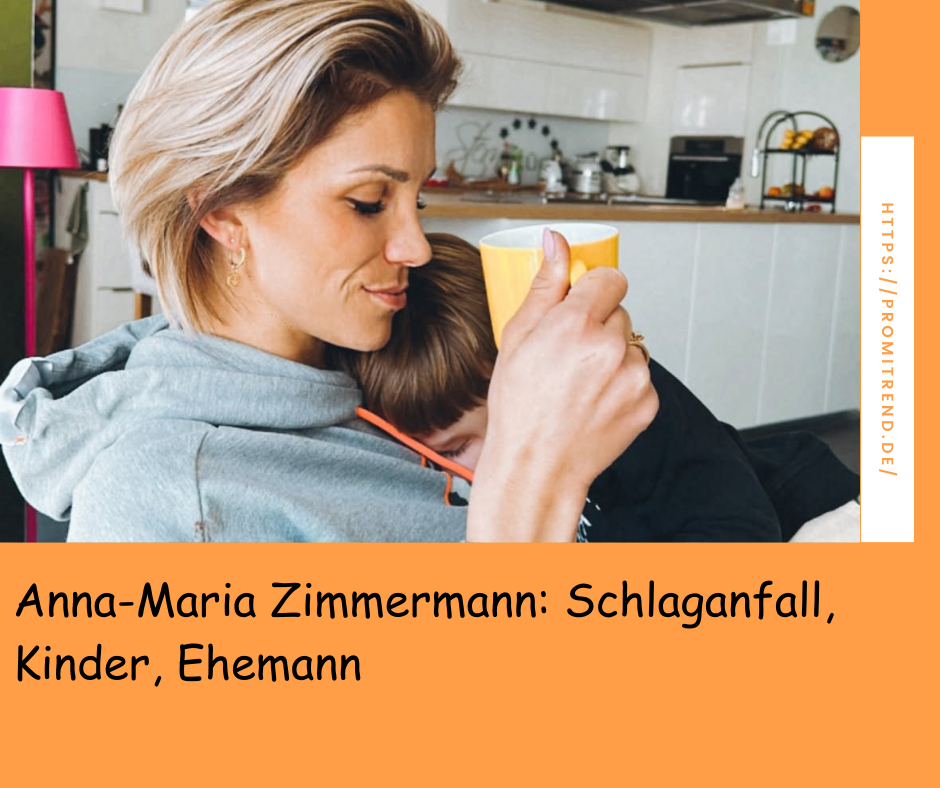 Eine Person mit kurzen blonden Haaren hält eine gelbe Tasse und umarmt ein Kind. Im Hintergrund ist eine Küche zu sehen. Der Text auf dem Bild lautet: "Anna-Maria Zimmermann: Schlaganfall, Kinder, Ehemann".