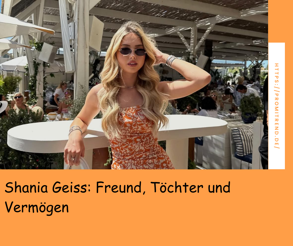 Eine Frau mit langen, welligen Haaren in einem orange-weißen Kleid lehnt an einem weißen Tisch in einem belebten Restaurant im Freien. Der Hintergrund zeigt andere Gäste und Pflanzen.